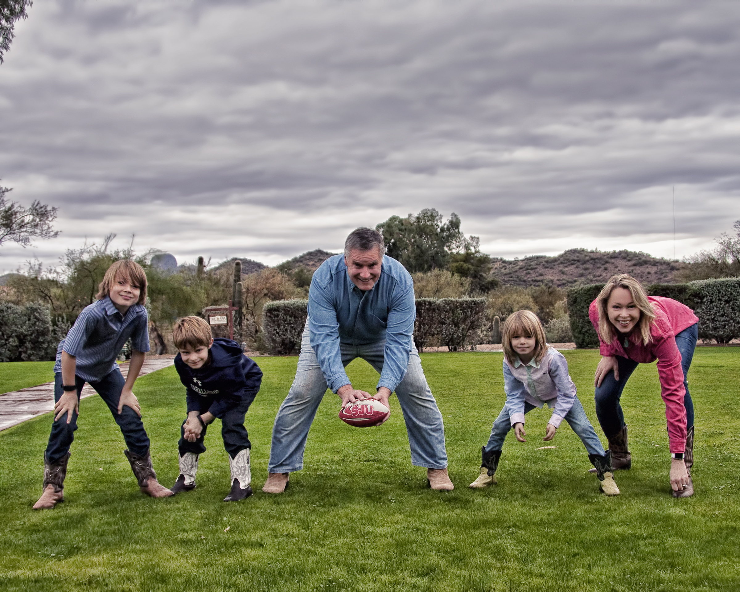 Jon Schwingler (center) and family hunched in football formation